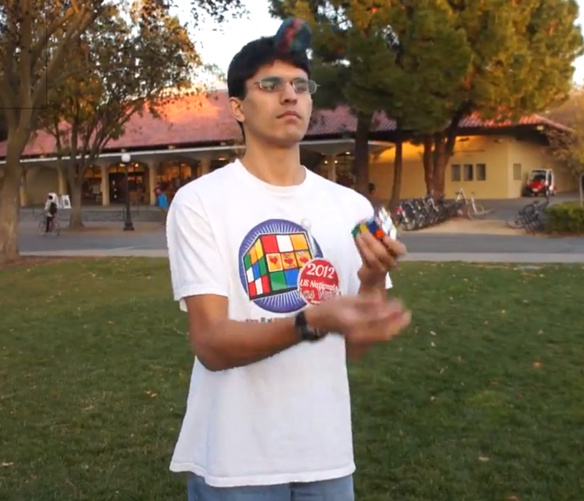 Boy Solves A Rubik's Cube While Juggling