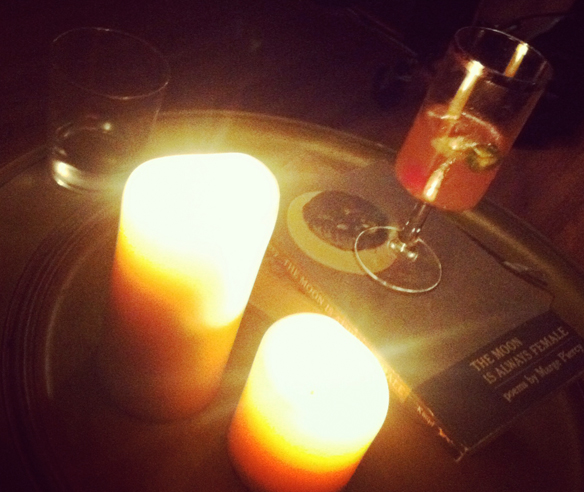 Recipe for calm: candles, poetry and an adult beverage.