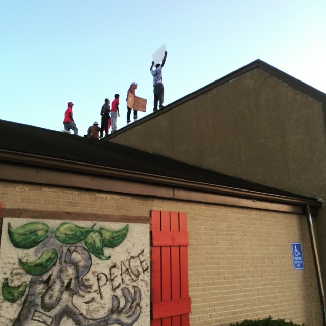 Ferguson protesters on a building