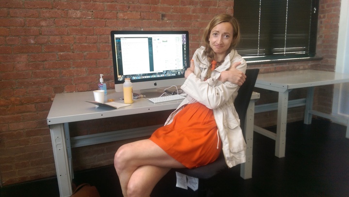 Thought Catalog's  Mélanie Berliet huddled up with a cozy cardigan in chilly office.