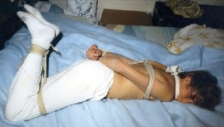 Photo of bound young male purported to be Johnny Gosch that was allegedly sent to his mother by his kidnappers. (YouTube)