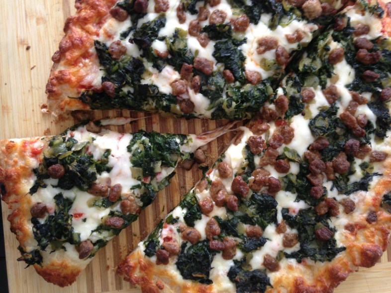 Pizza with turkey sausage, spinach and pesto