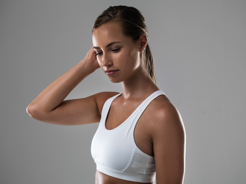 Shot of an attractive woman pushing a stray hair behind her ear during a workout