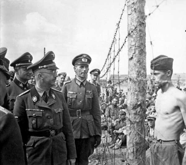 Heinrich Himmler inspects concentration camp. Horace Greasley is at right with no shirt. (Wikimedia Commons) 