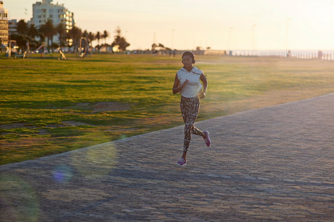 Athlete running in city park