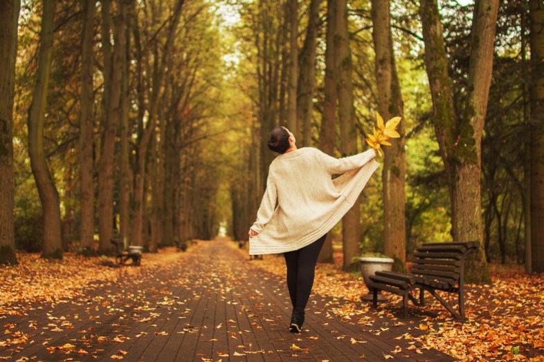 girl walking in the park in autumn