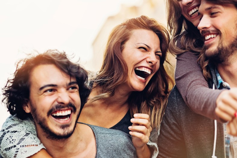 Two couples having fun outdoors in the city.