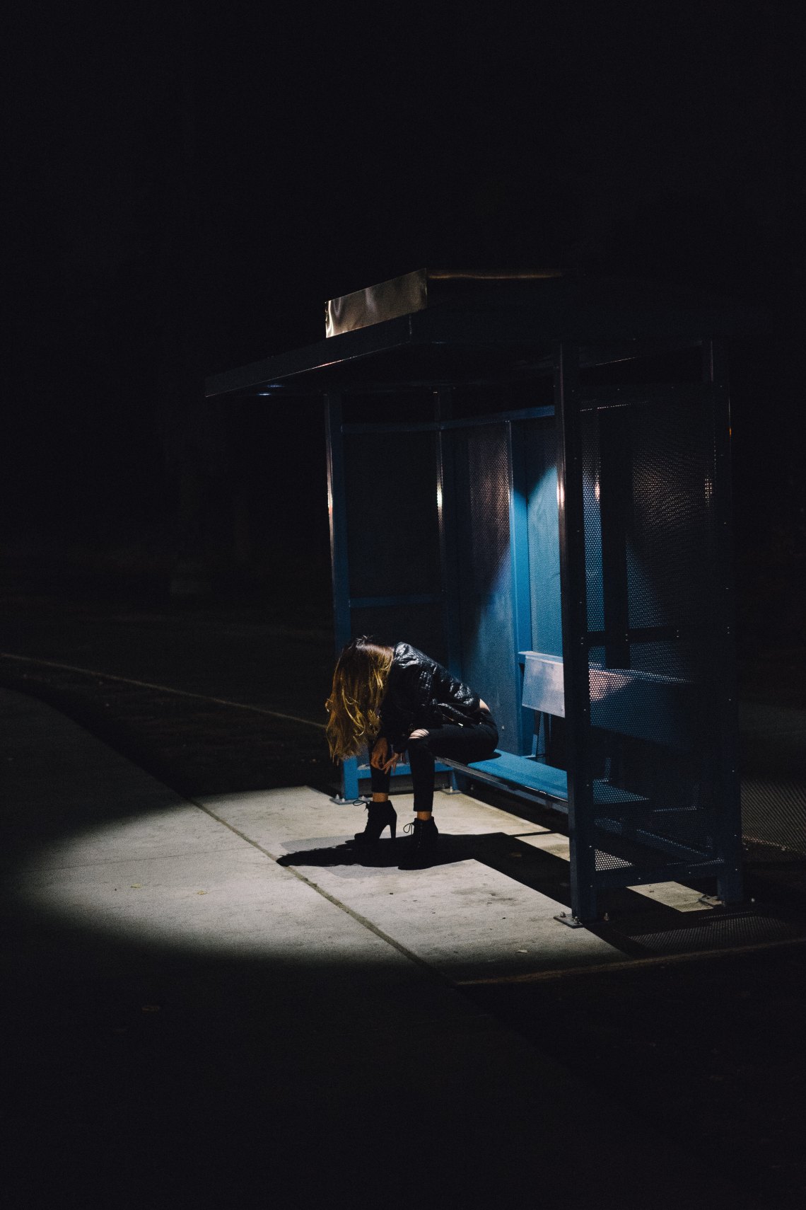 student at bus stop