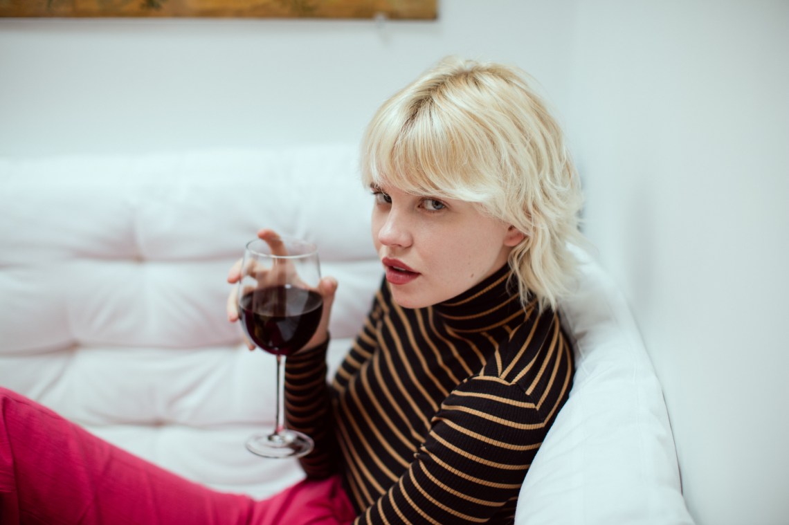Girl Drinking Wine On The Couch Sassily