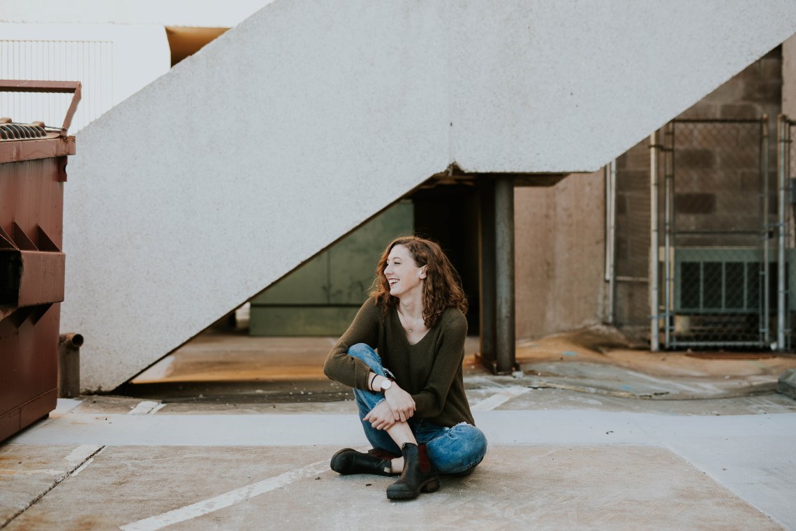 Woman sitting on concrete