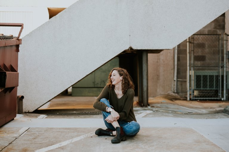 Woman sitting on concrete