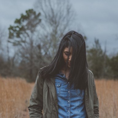 Woman walking through woods