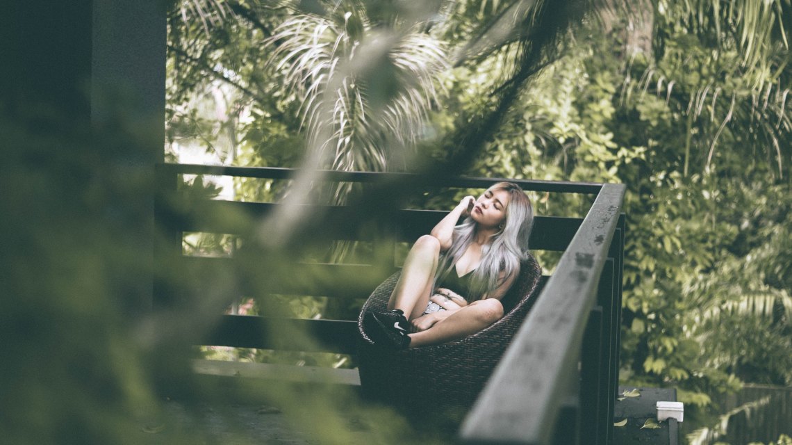 Girl sitting on deck in chair