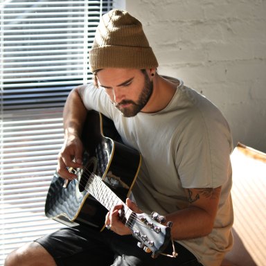 Guy in beanie playing guitar