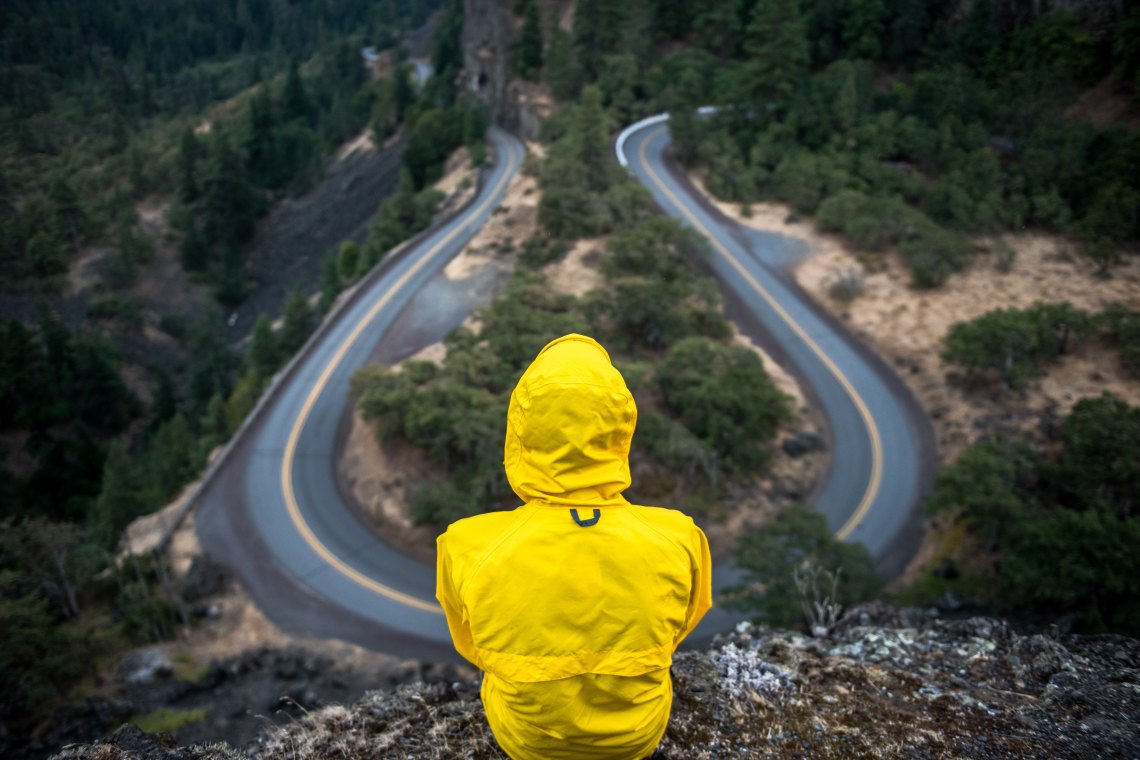 man in yellow coat looking out