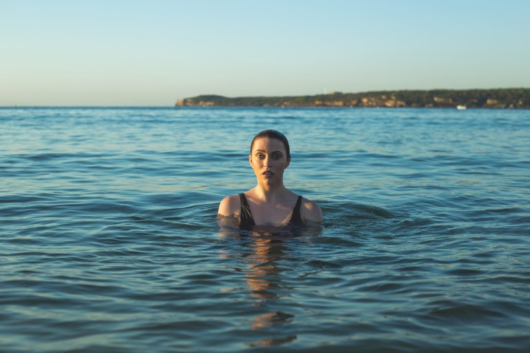 A woman swims in the middle of the ocean