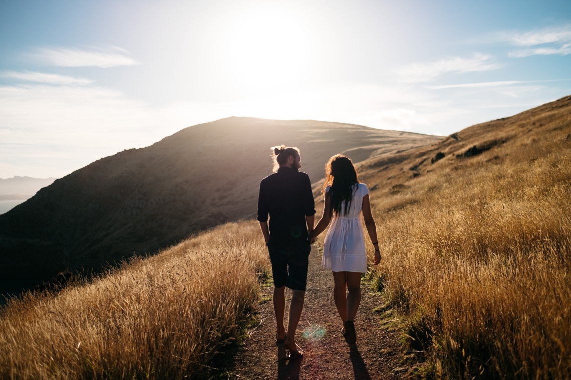 Couple holding hands and hiking