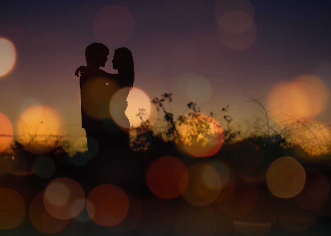 Couple's silhouette against sunset