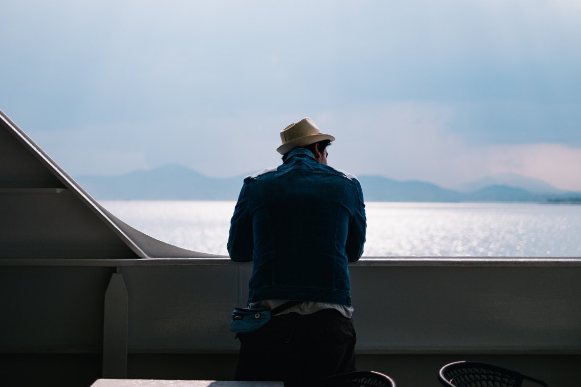 Guy with hat looking over water