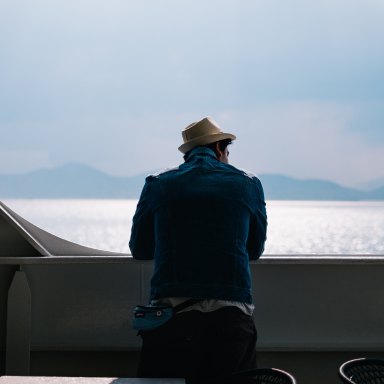 Guy with hat looking over water