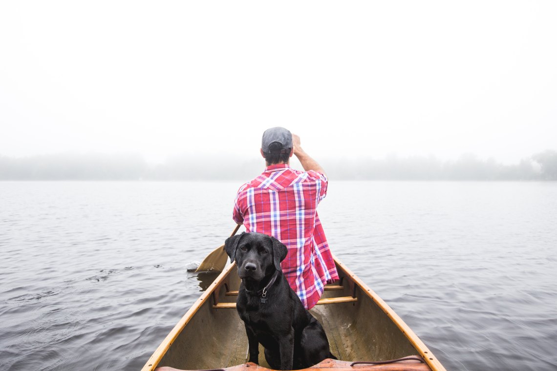 Guy in canoe with dog