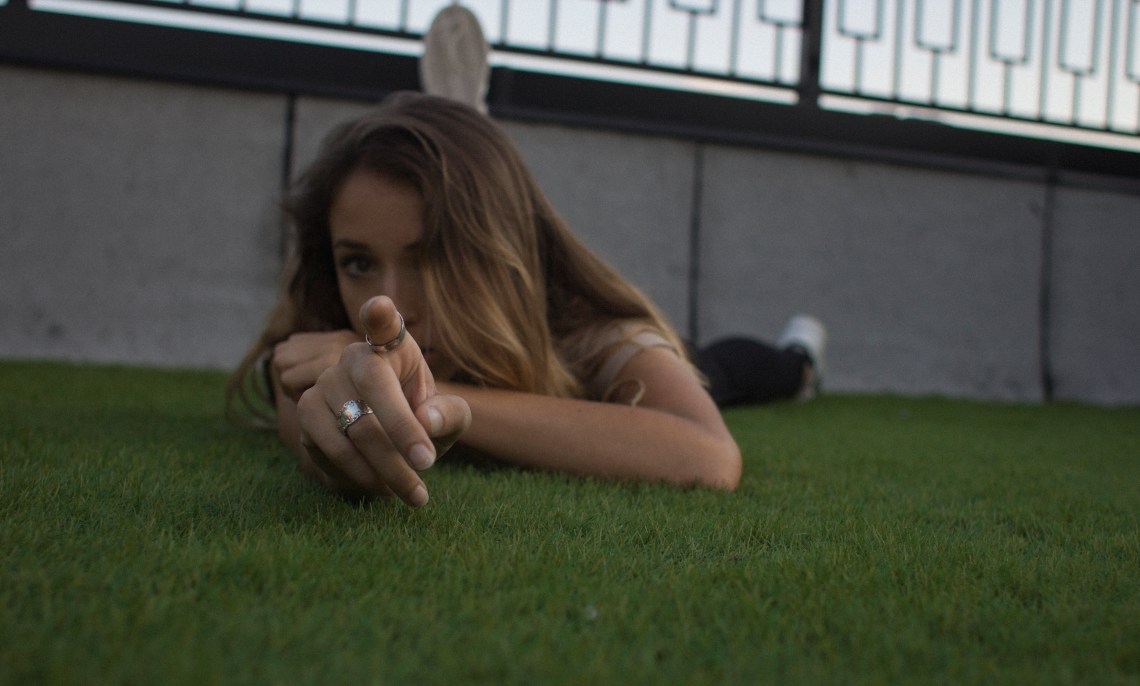 girl pointing at camera