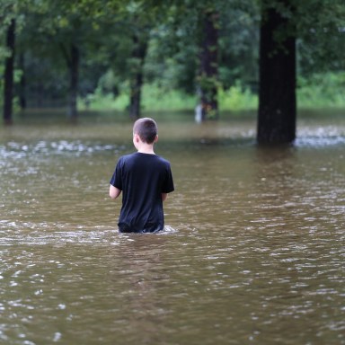 Boy stands in the flood waters during Hurricane Harvey in Texas