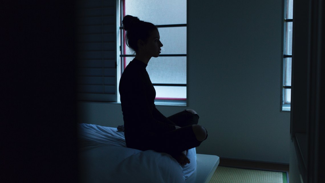 woman sitting in dark