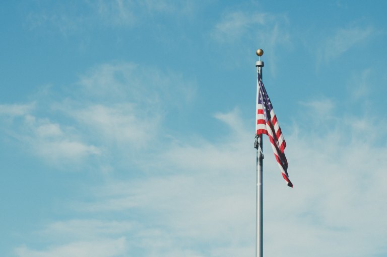 A single american flag waving in the wind