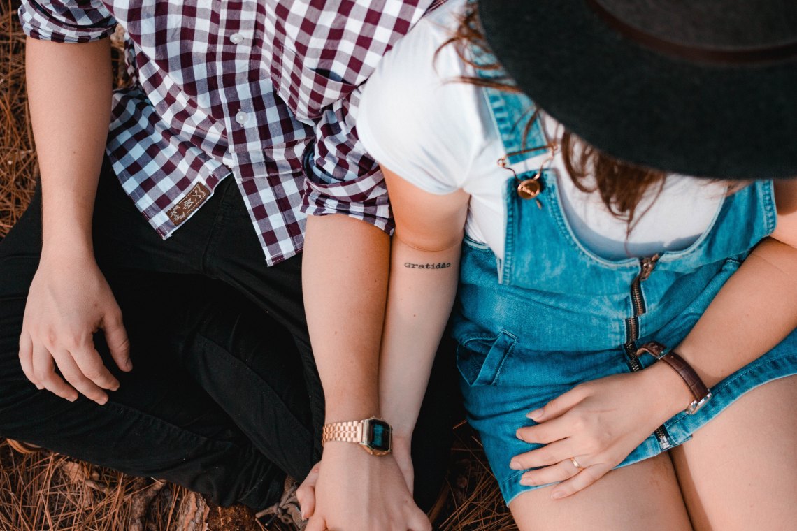 A couple holds hands lovingly