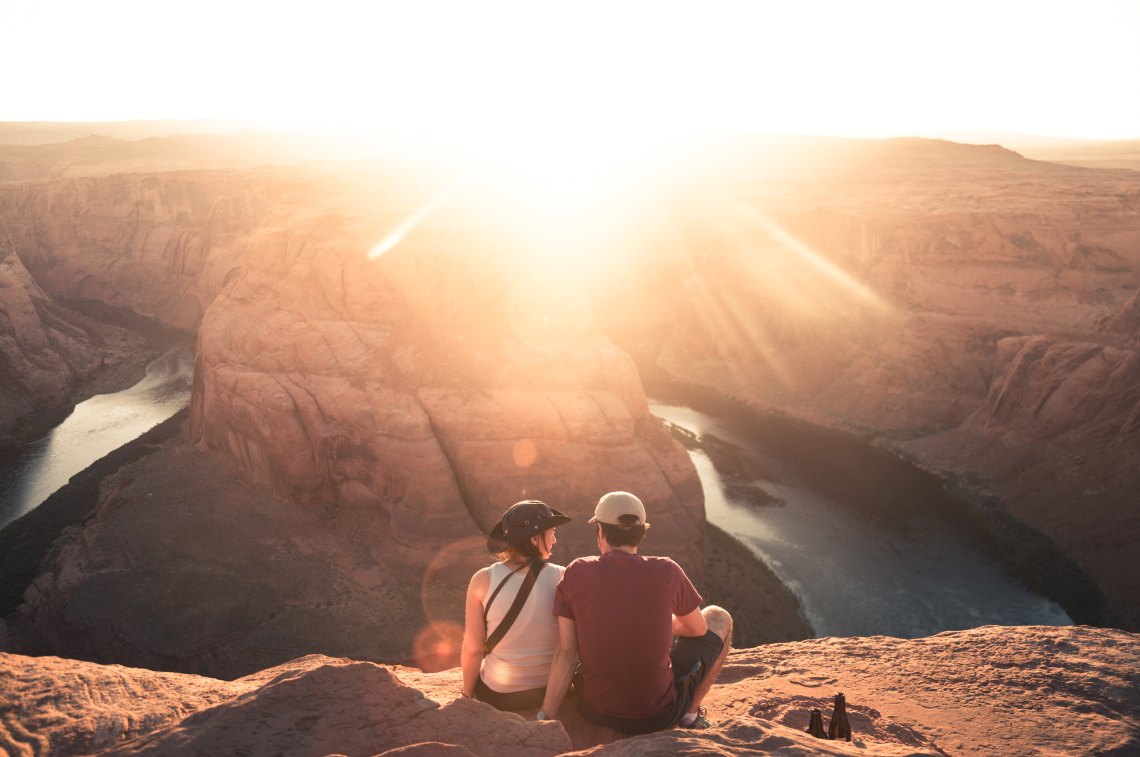 Couple sitting in front of canyon