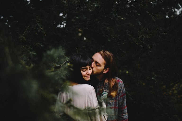 couple kissing in woods