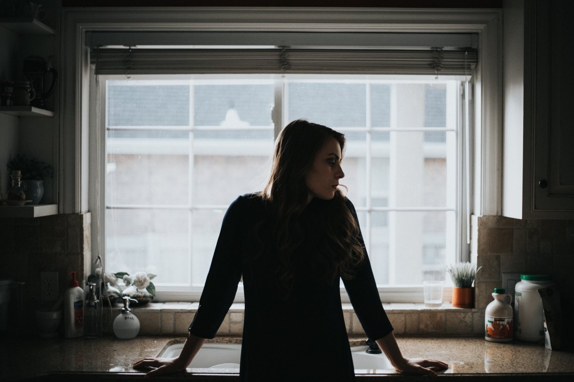 woman standing in front of window