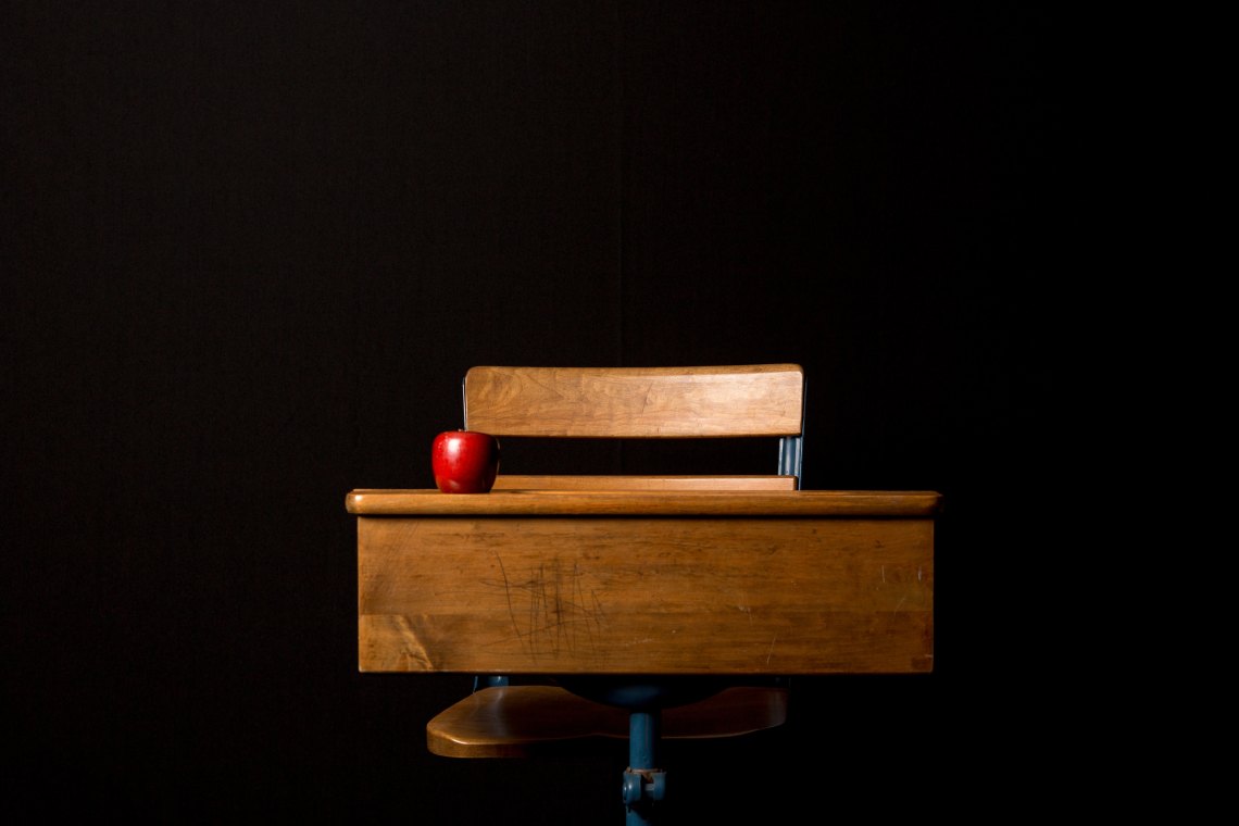 a school desk with an apple on it