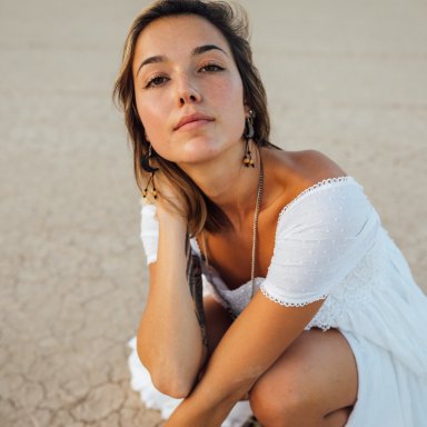 Woman in white dress with brown background