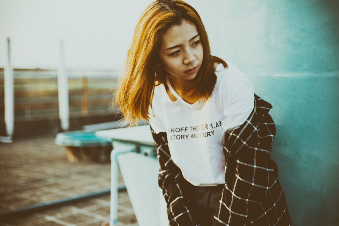 Girl standing against wall