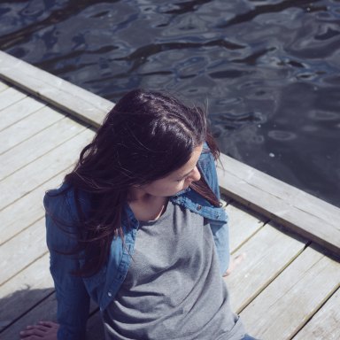 girl sitting on dock