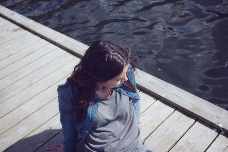girl sitting on dock