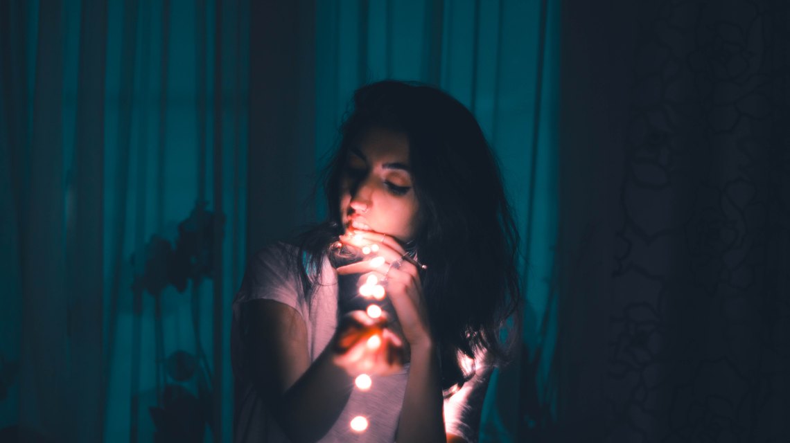girl in dark with lights
