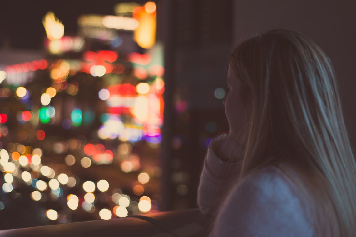 girl looking at city at night