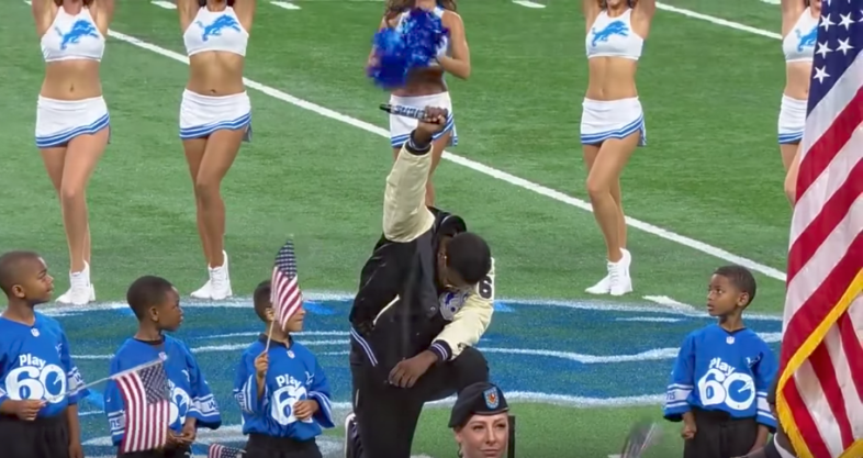 Singer kneels during the national anthem at an NFL game