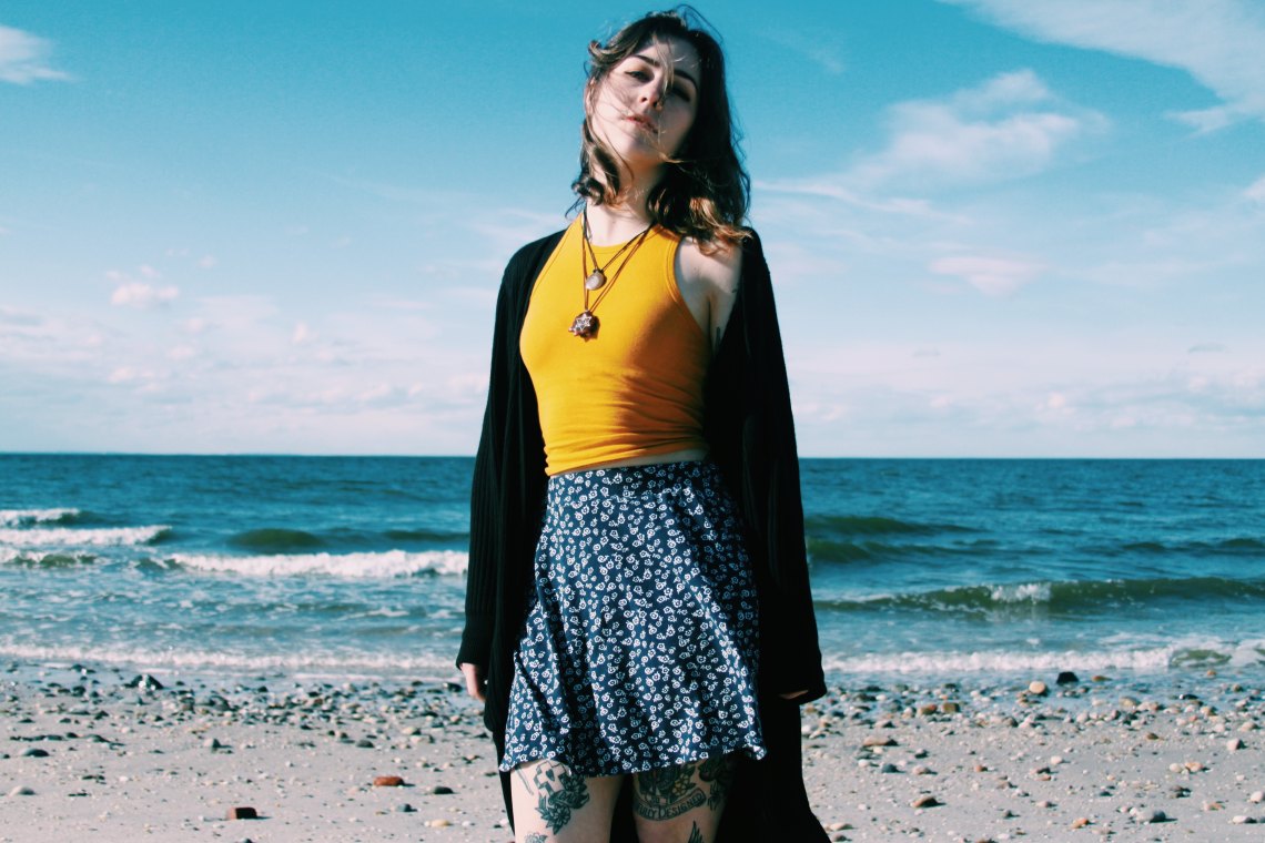 Girl in skirt standing on beach