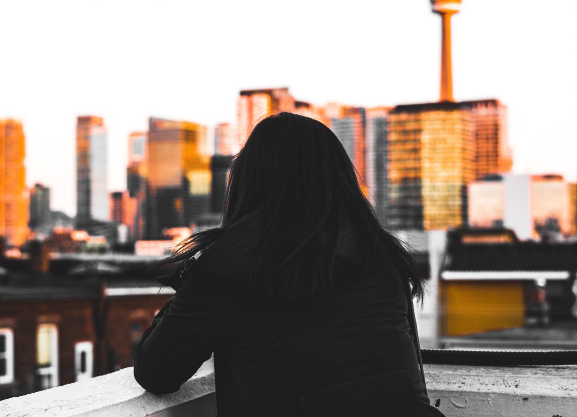girl looking out at city, abusive relationship 