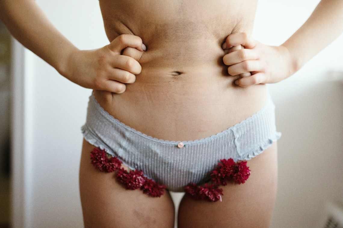 Women stands in underwear with roses tucked inside it