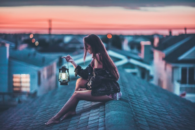 girl on rooftop with vintage lamp