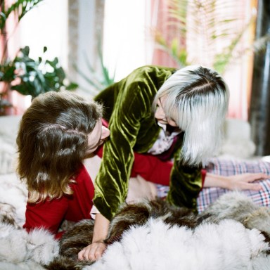Dating Couple Ecstatically Sharing Laughs and Love on a Furry Bed