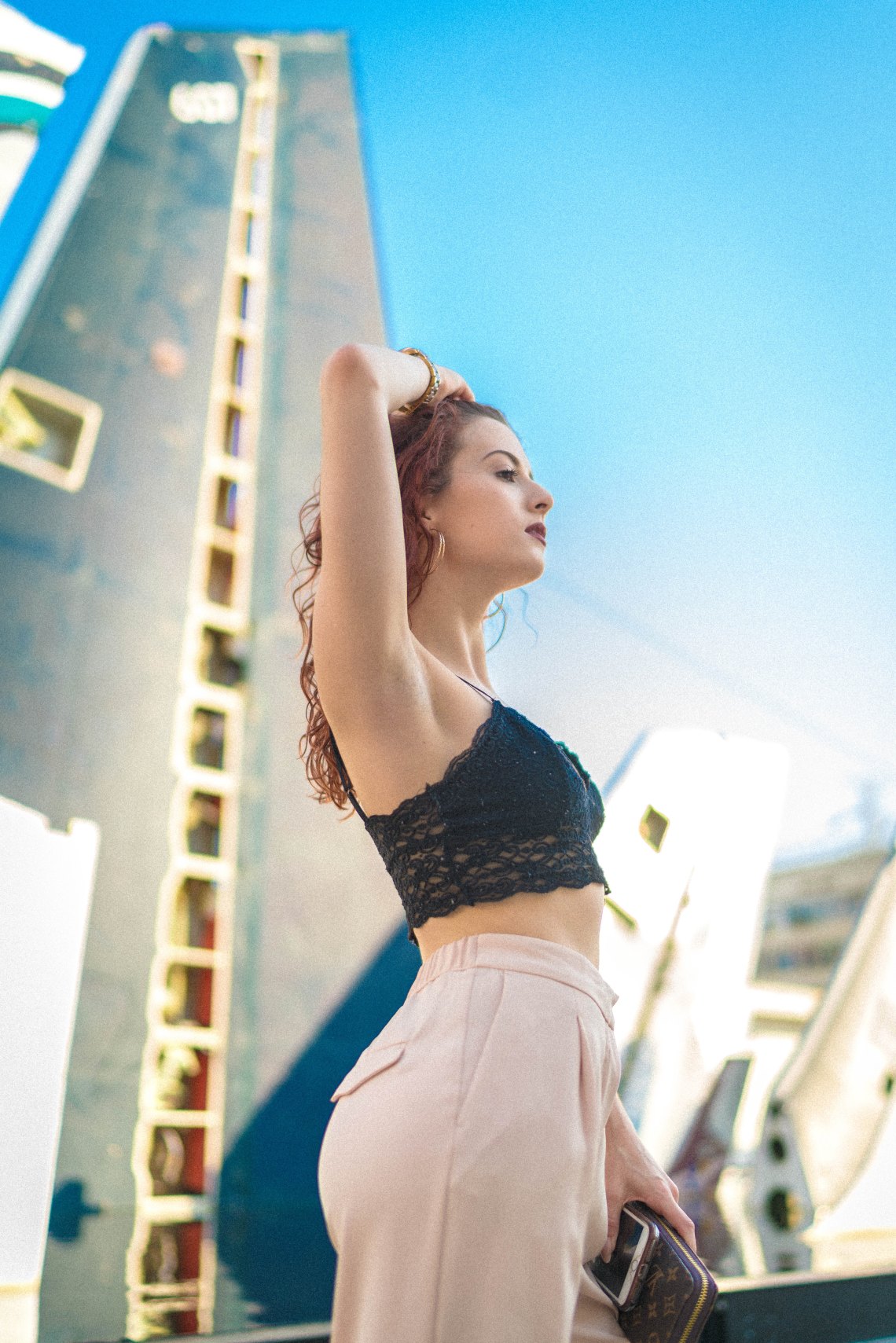 tall girl in front of city skyline
