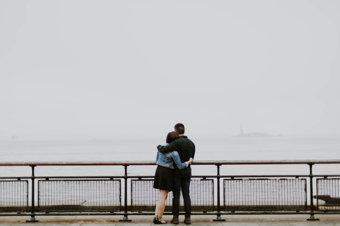 Couple hugging in front of water