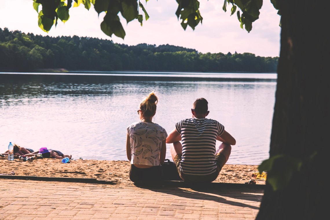 couple sitting by water