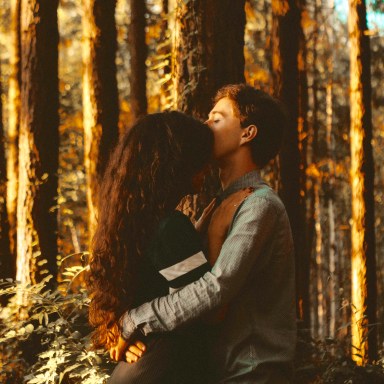 Couple hugging in forest